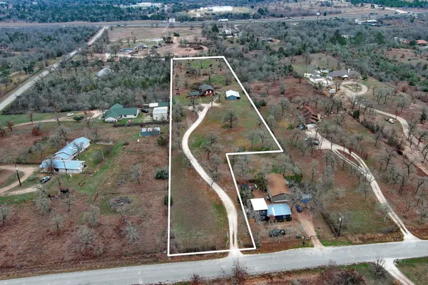 an aerial view of a house with a yard