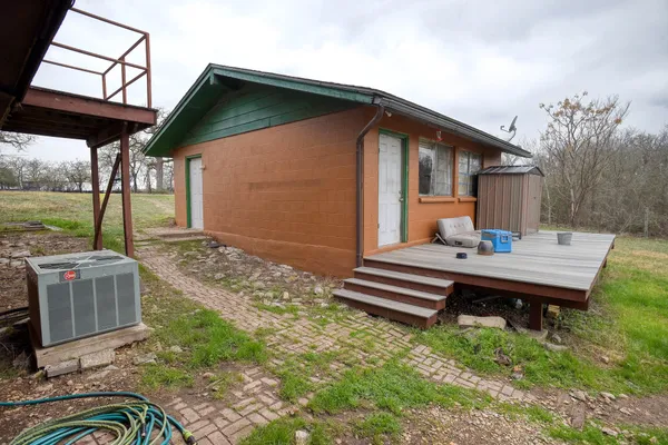 a backyard of a house with a garden and barbeque oven