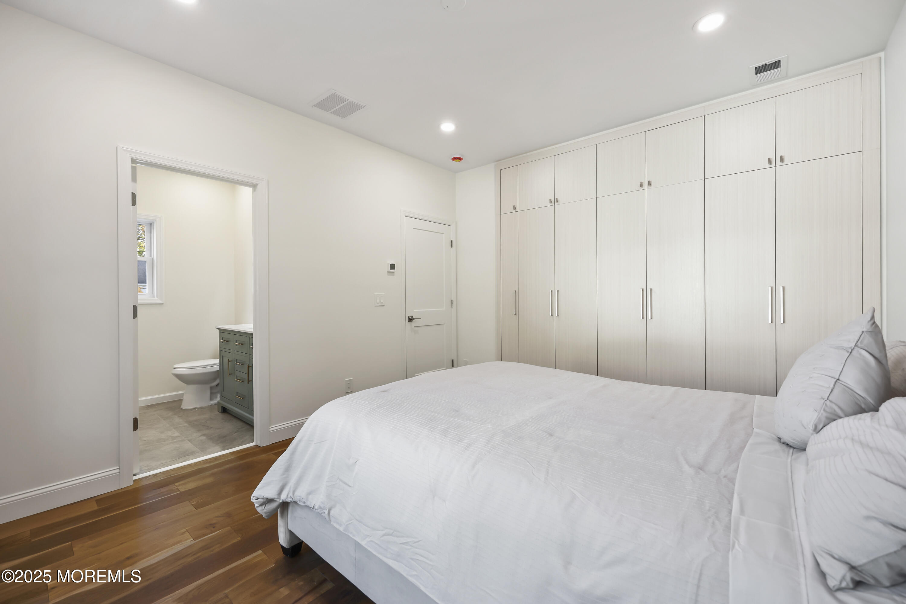 a spacious bedroom with a bed and a view of bathroom
