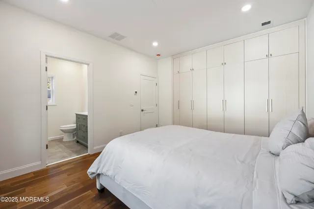 a spacious bedroom with a bed and a view of bathroom
