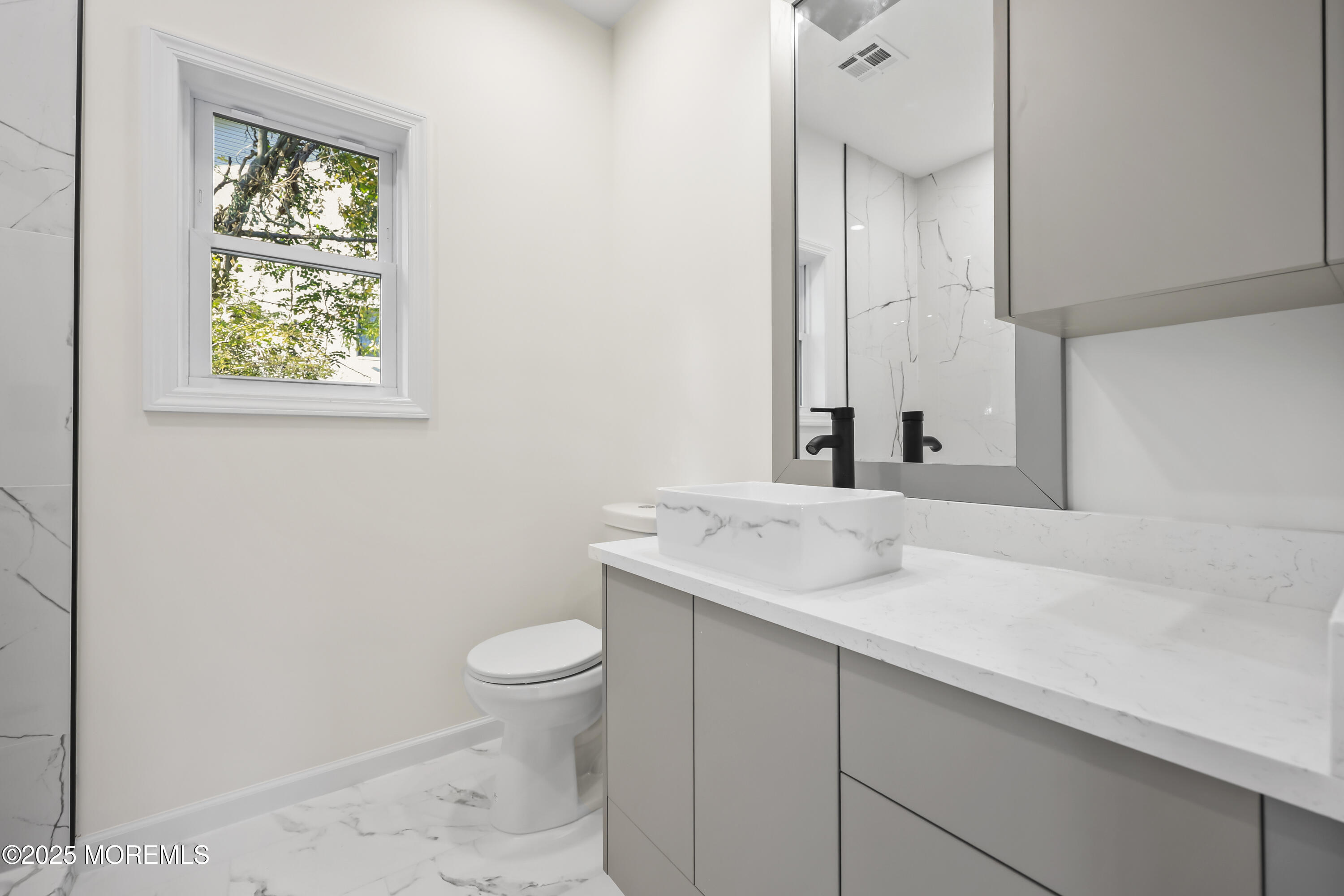 188 Texas Road Morganville, NJ 07751 - Photo 18 of 21 a bathroom with a granite countertop sink a toilet and a mirror