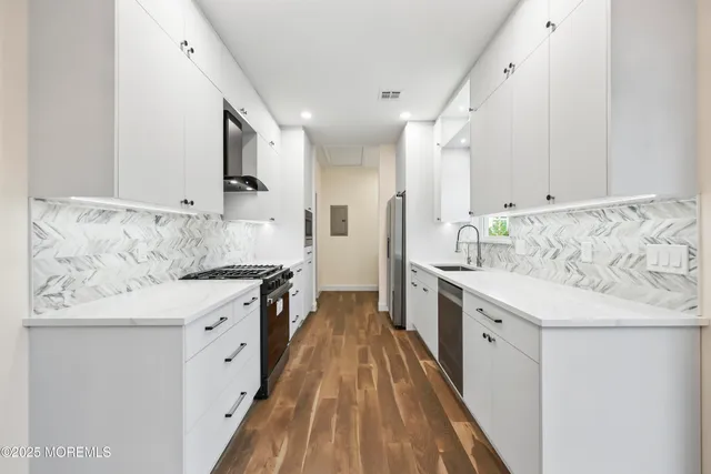 a kitchen with granite countertop white cabinets and white appliances