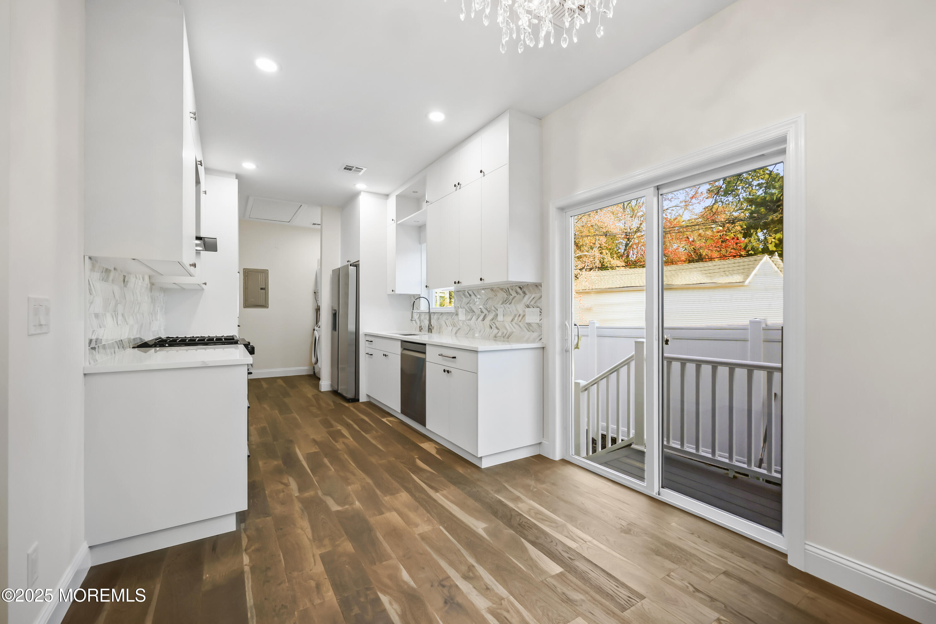 188 Texas Road Morganville, NJ 07751 - Photo 6 of 21 a kitchen with stainless steel appliances granite countertop a stove a sink and a refrigerator