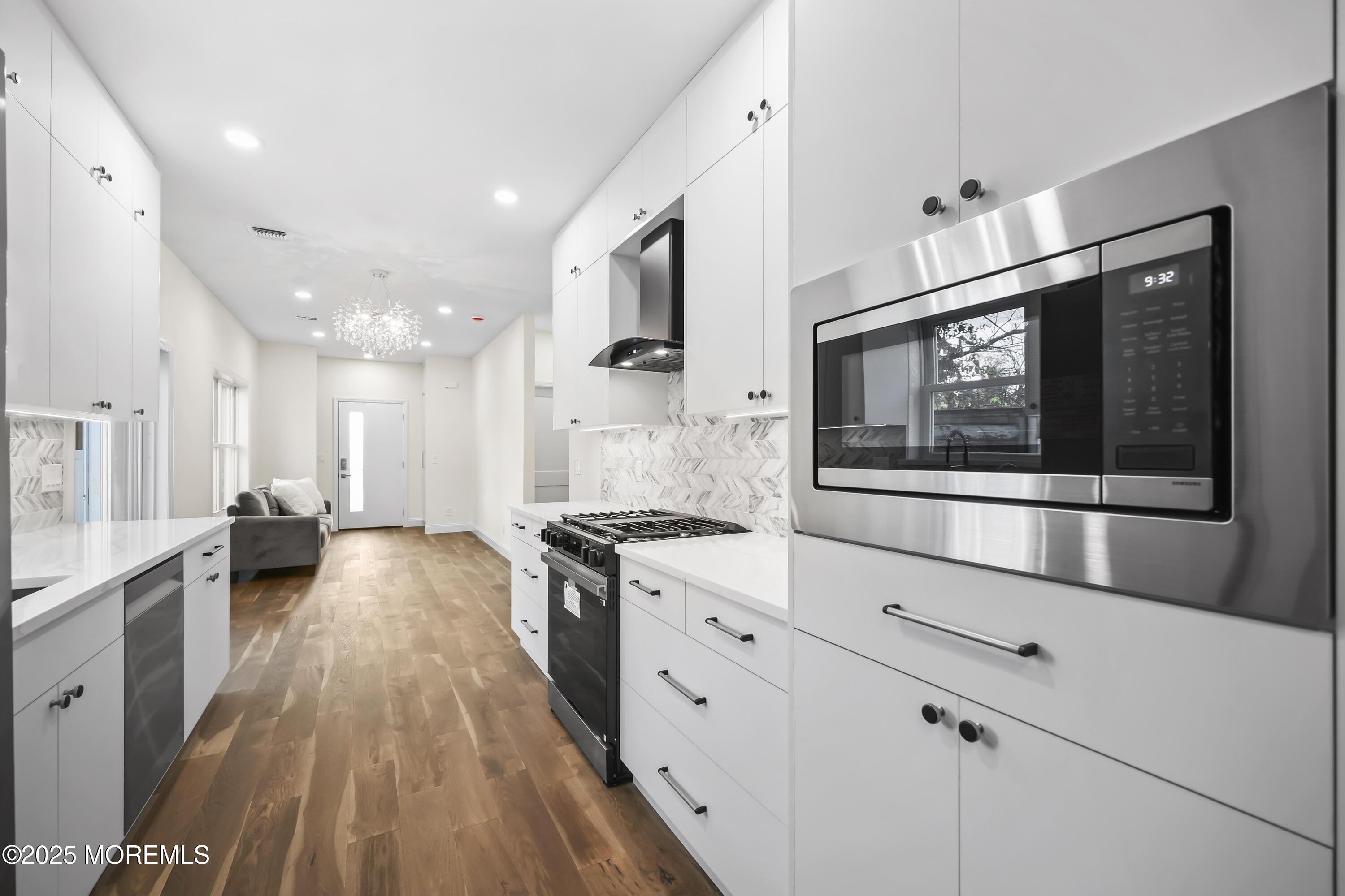 188 Texas Road Morganville, NJ 07751 - Photo 7 of 21 a large kitchen with stainless steel appliances a stove a sink and a microwave