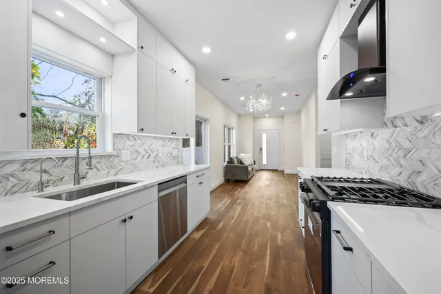 a kitchen with sink stove and refrigerator