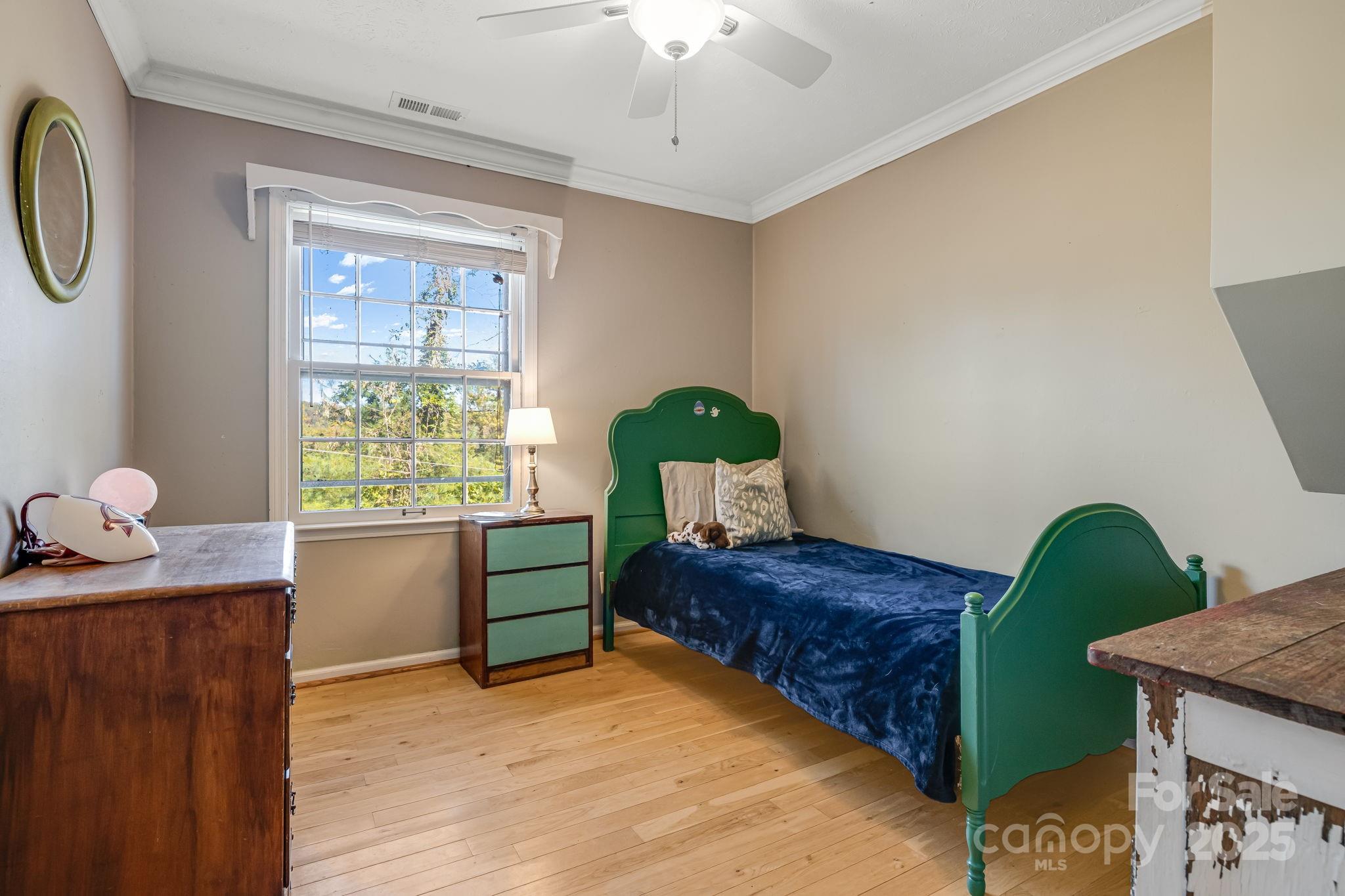 203 Davis Mountain Road Laurel Park, NC 28739 - Photo 11 of 37 a bedroom with a bed and a window