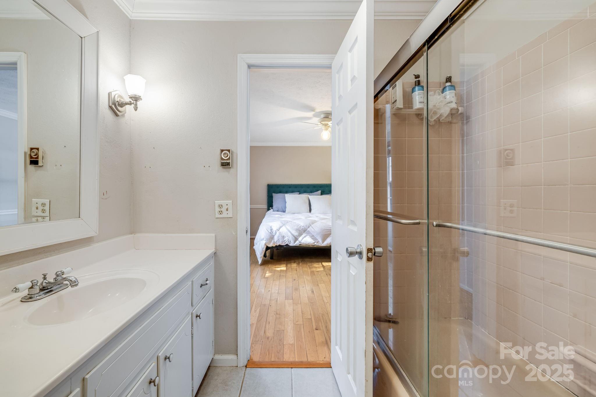 203 Davis Mountain Road Laurel Park, NC 28739 - Photo 15 of 37 a bathroom with a sink and shower