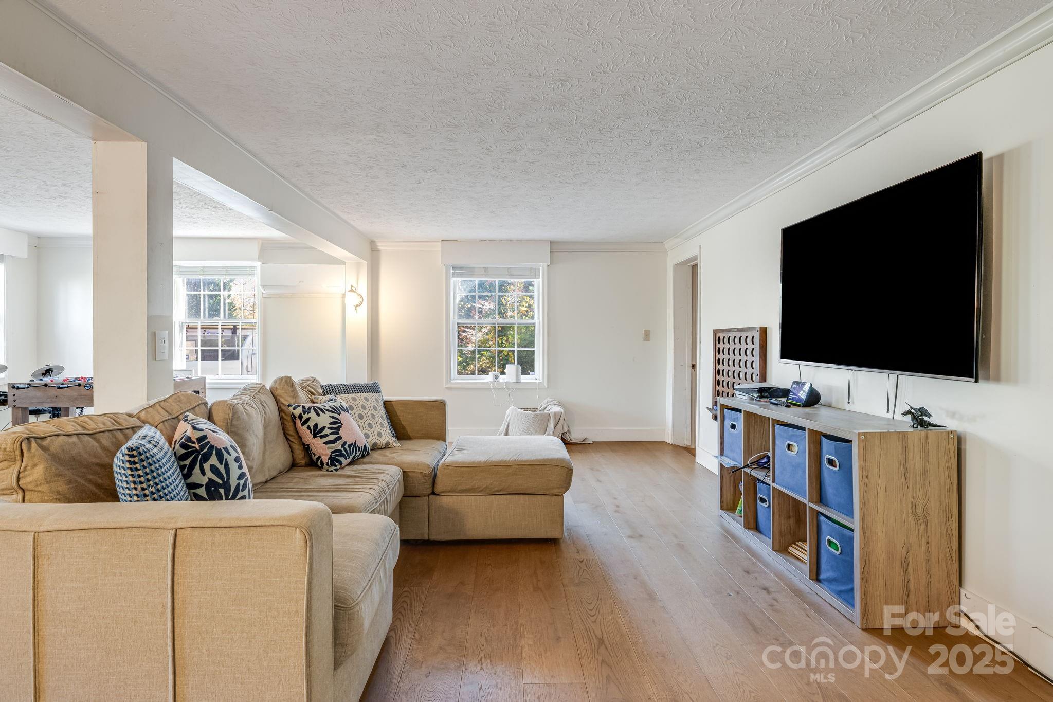 203 Davis Mountain Road Laurel Park, NC 28739 - Photo 23 of 37 a living room with furniture and a flat screen tv