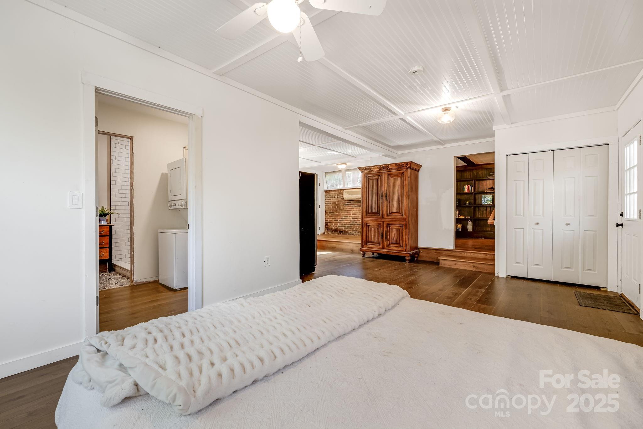 203 Davis Mountain Road Laurel Park, NC 28739 - Photo 29 of 37 a bedroom with a large bed and wooden floor