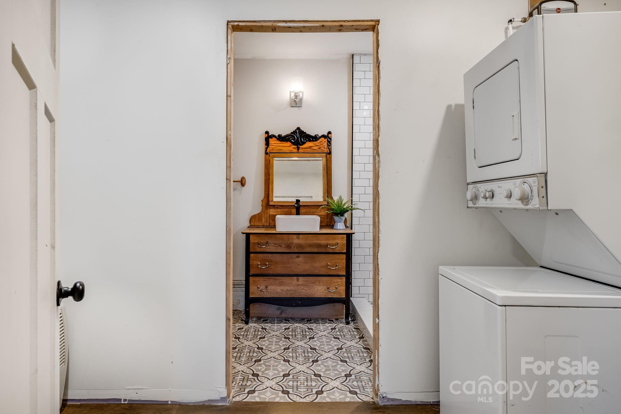 203 Davis Mountain Road Laurel Park, NC 28739 - Photo 30 of 37 a view of a bedroom with baby crib and cabinet
