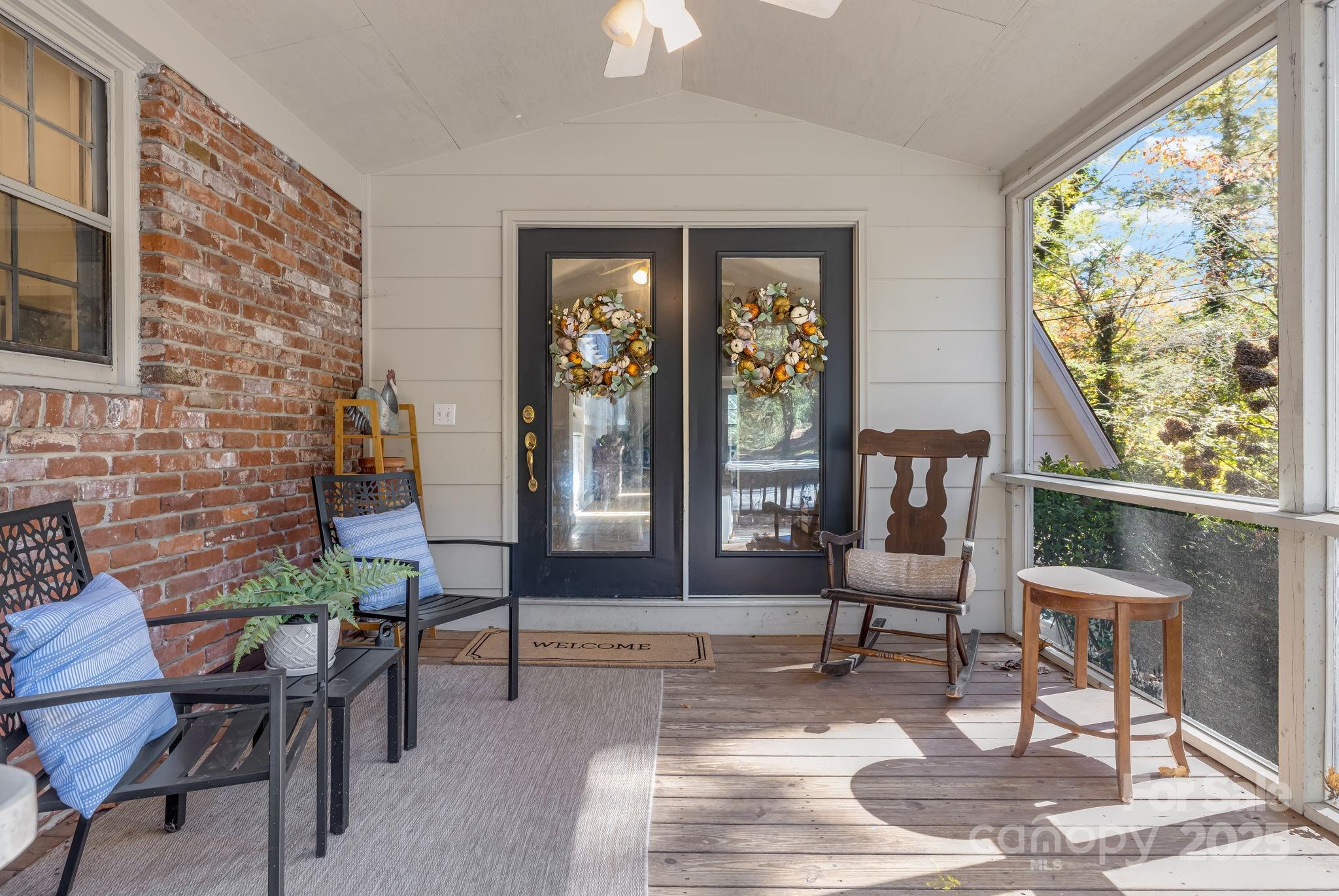 203 Davis Mountain Road Laurel Park, NC 28739 - Photo 32 of 37 a living room with furniture and a floor to ceiling window