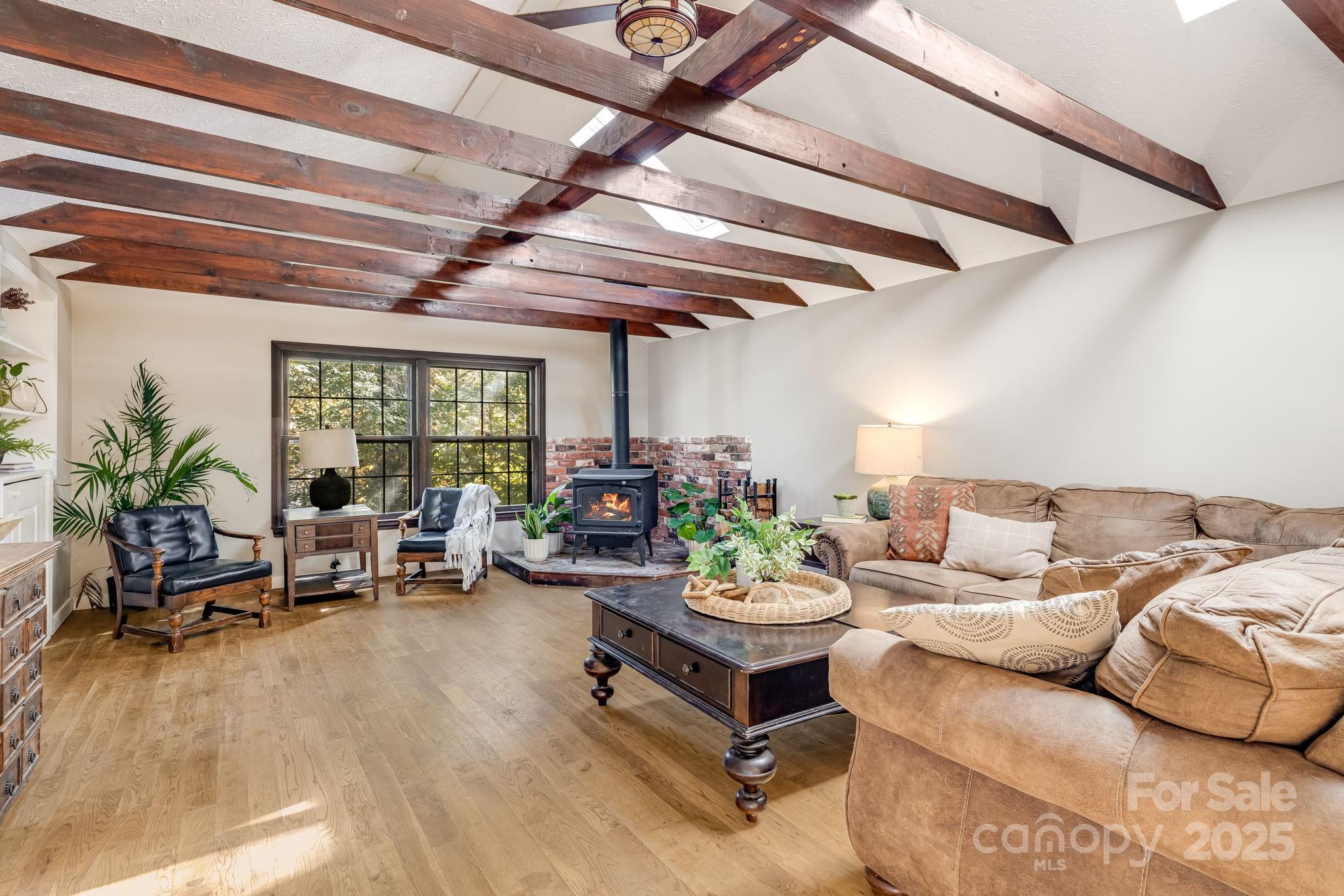 203 Davis Mountain Road Laurel Park, NC 28739 - Photo 4 of 37 a living room with furniture and a potted plant