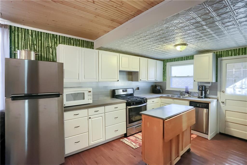 20 Deweyville Road McKees Rocks, PA 15136 - Photo 11 of 25 a kitchen with white cabinets and white appliances