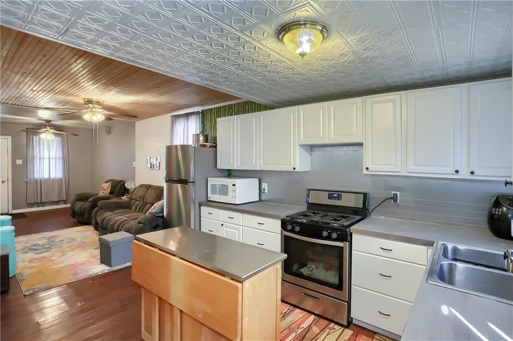 20 Deweyville Road McKees Rocks, PA 15136 - Photo 15 of 25 a kitchen with a stove cabinets and a wooden floor