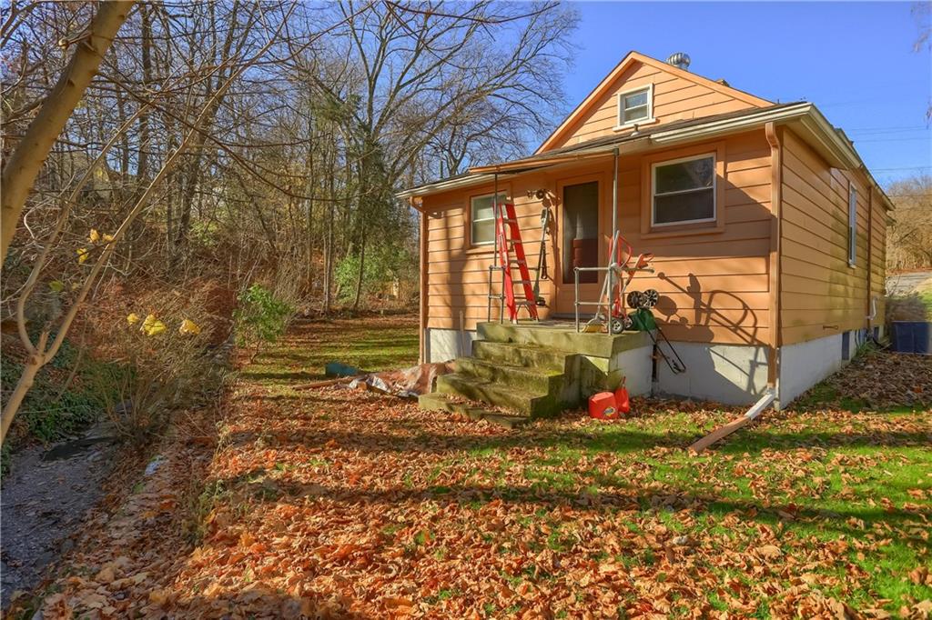 20 Deweyville Road McKees Rocks, PA 15136 - Photo 5 of 25 a view of a house with a small yard and wooden fence