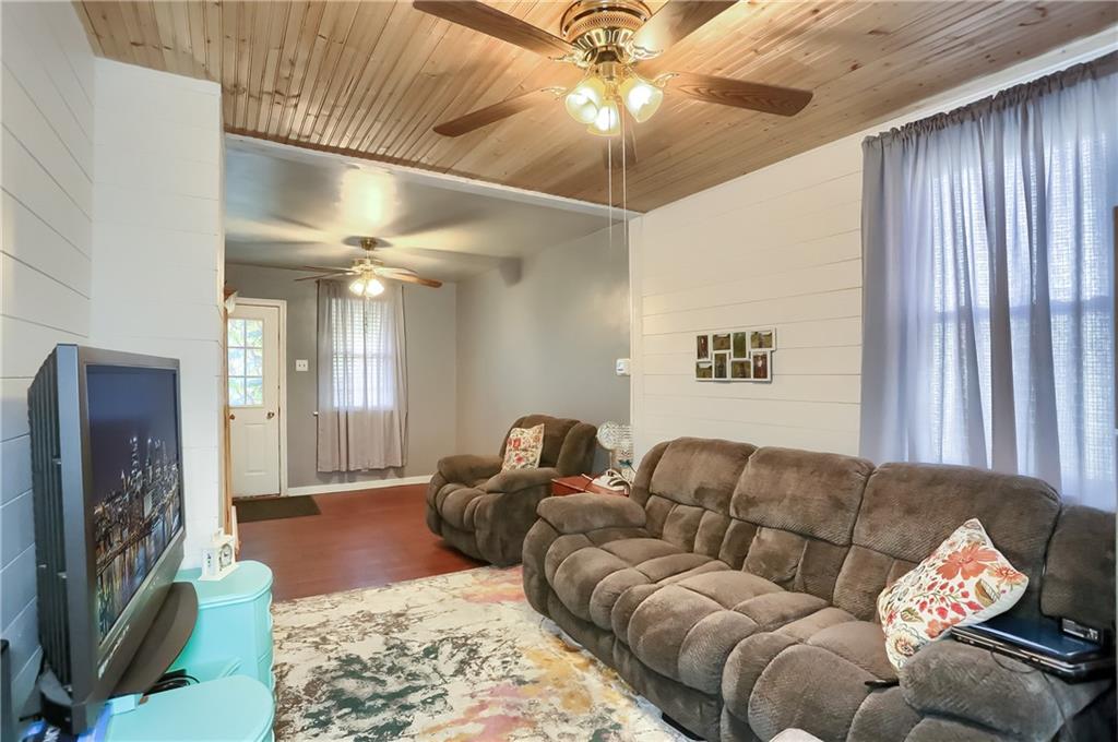 20 Deweyville Road McKees Rocks, PA 15136 - Photo 8 of 25 a living room with furniture a chandelier and a flat screen tv