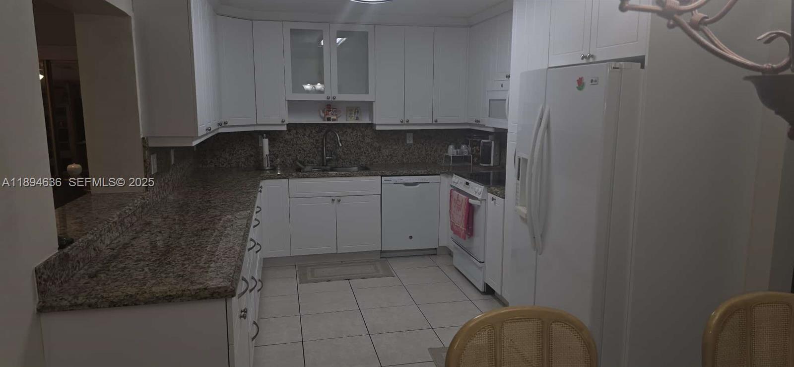 7160 West 10th Avenue Hialeah, FL 33014 - Photo 12 of 45 a kitchen with a sink and cabinets