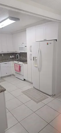 a bathroom with a mirror and a chair