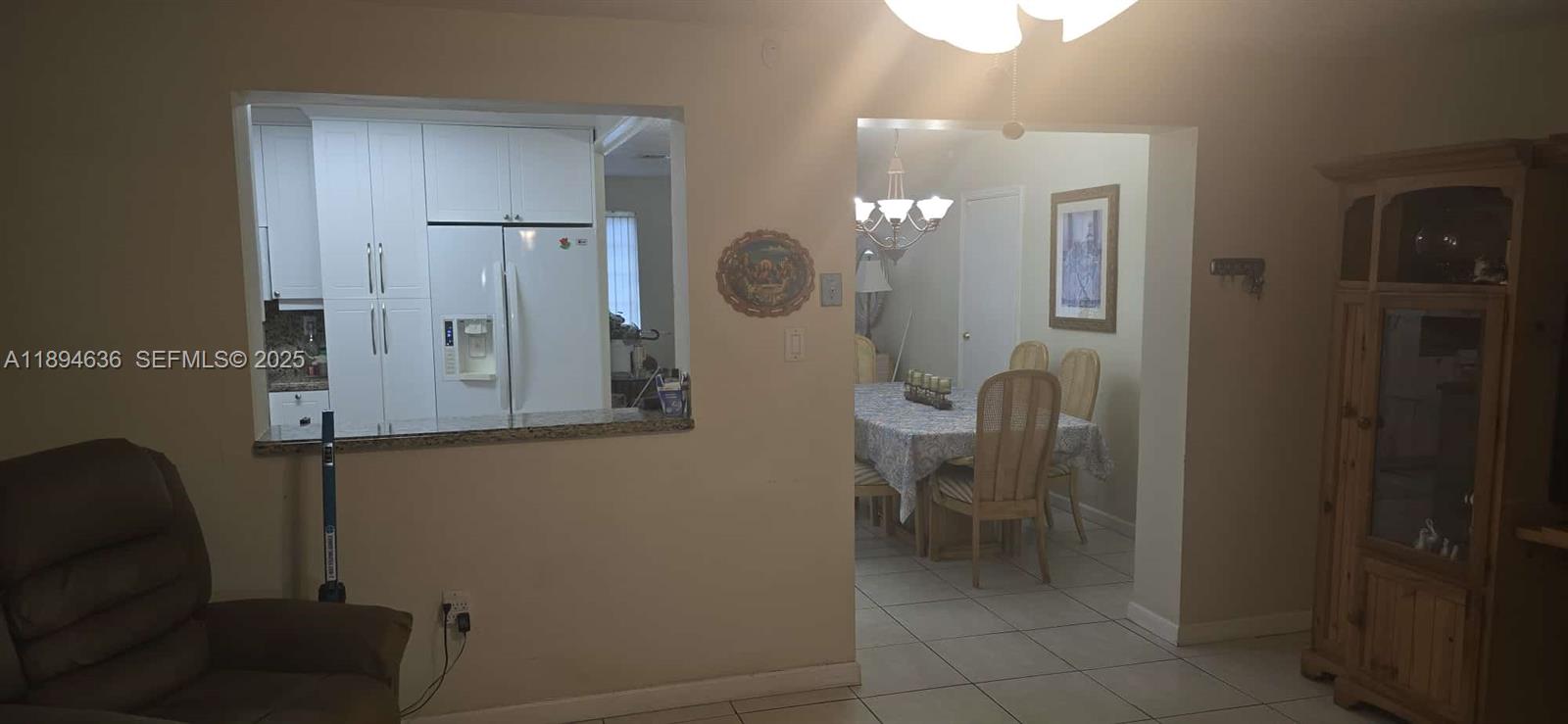 7160 West 10th Avenue Hialeah, FL 33014 - Photo 15 of 45 a bathroom with a mirror and a chair