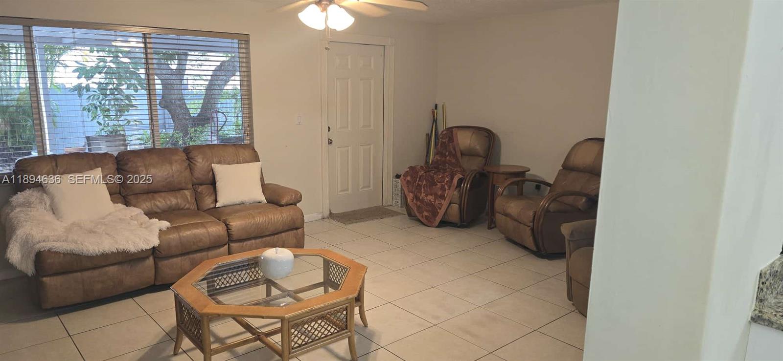 7160 West 10th Avenue Hialeah, FL 33014 - Photo 19 of 45 a living room with furniture and a large window