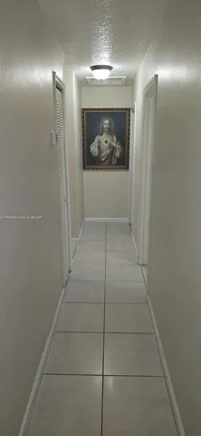 a bedroom with a bed and a lamp on the table