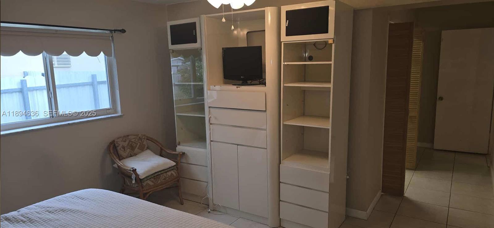 7160 West 10th Avenue Hialeah, FL 33014 - Photo 24 of 45 a room with a chair and a window