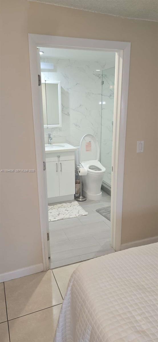 7160 West 10th Avenue Hialeah, FL 33014 - Photo 28 of 45 a bathroom with a sink a toilet and a mirror