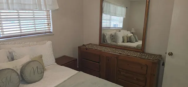 a bedroom with a bed and with glass door