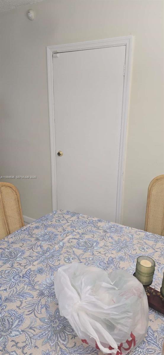 7160 West 10th Avenue Hialeah, FL 33014 - Photo 40 of 45 a bedroom with a bed and a window