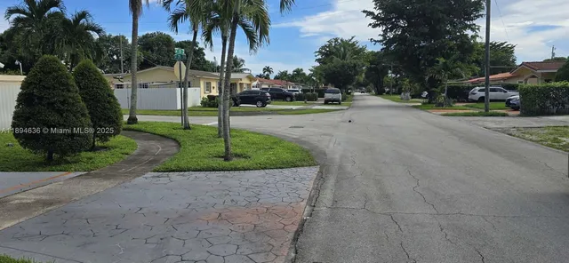 a view of a street with a building and a street sign