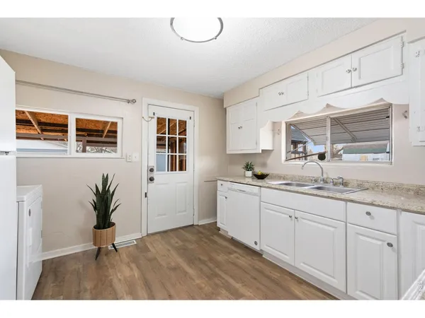 a kitchen with sink and cabinets