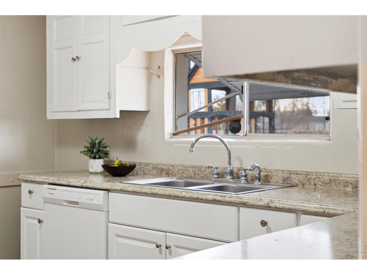 1416 6th Street Greeley, CO 80631 - Photo 14 of 50 a kitchen with granite countertop a sink stainless steel appliances and cabinets