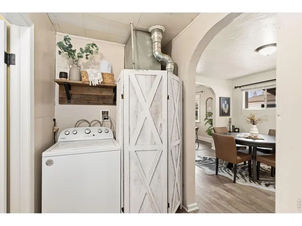 a view of a workspace with furniture and wooden floor