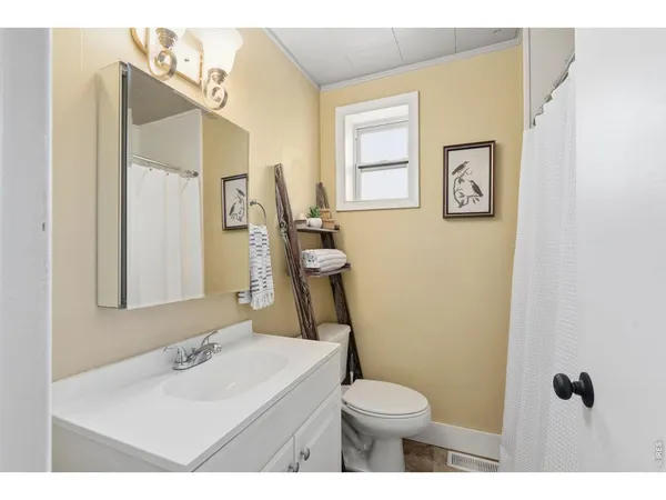 a bathroom with a sink toilet and mirror