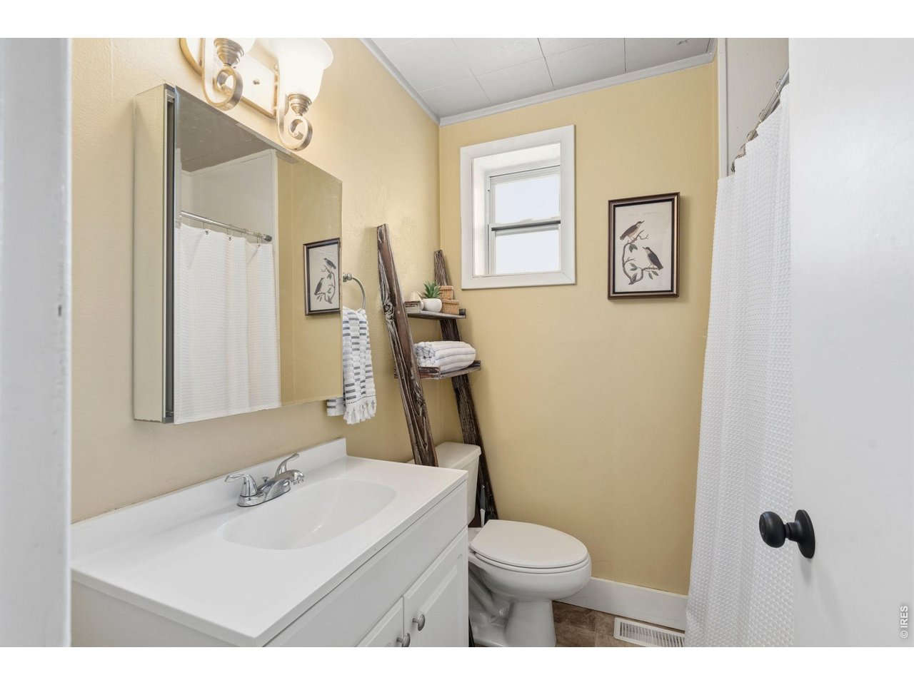 1416 6th Street Greeley, CO 80631 - Photo 17 of 50 a bathroom with a sink toilet and mirror