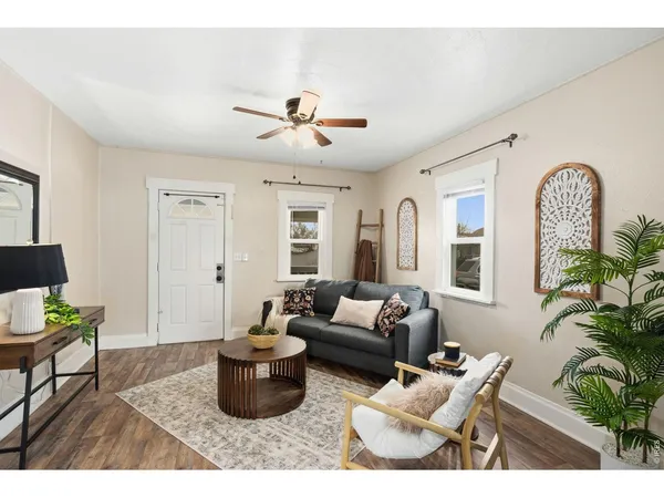 a living room with furniture potted plant and a window