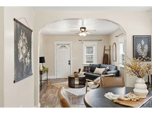 a living room with furniture and a chandelier