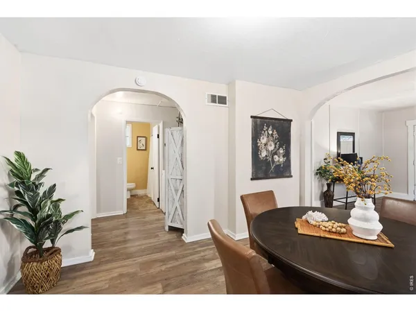 a view of a dining room with furniture and wooden floor