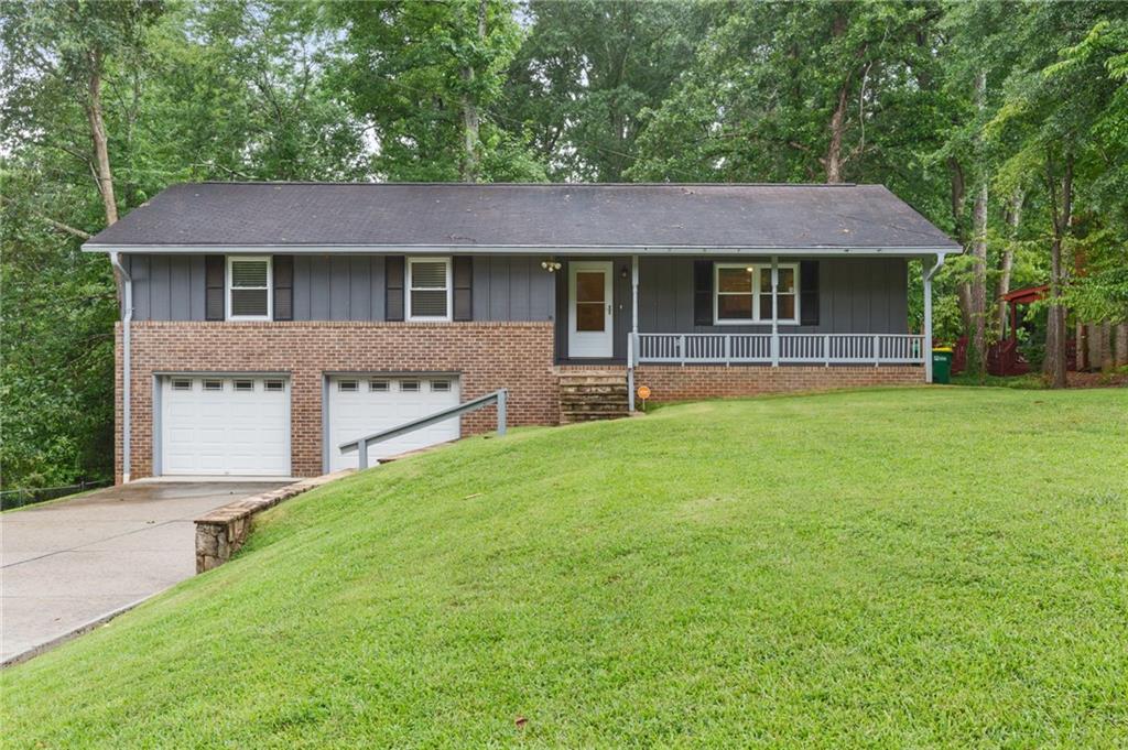 a front view of a house with a garden and yard
