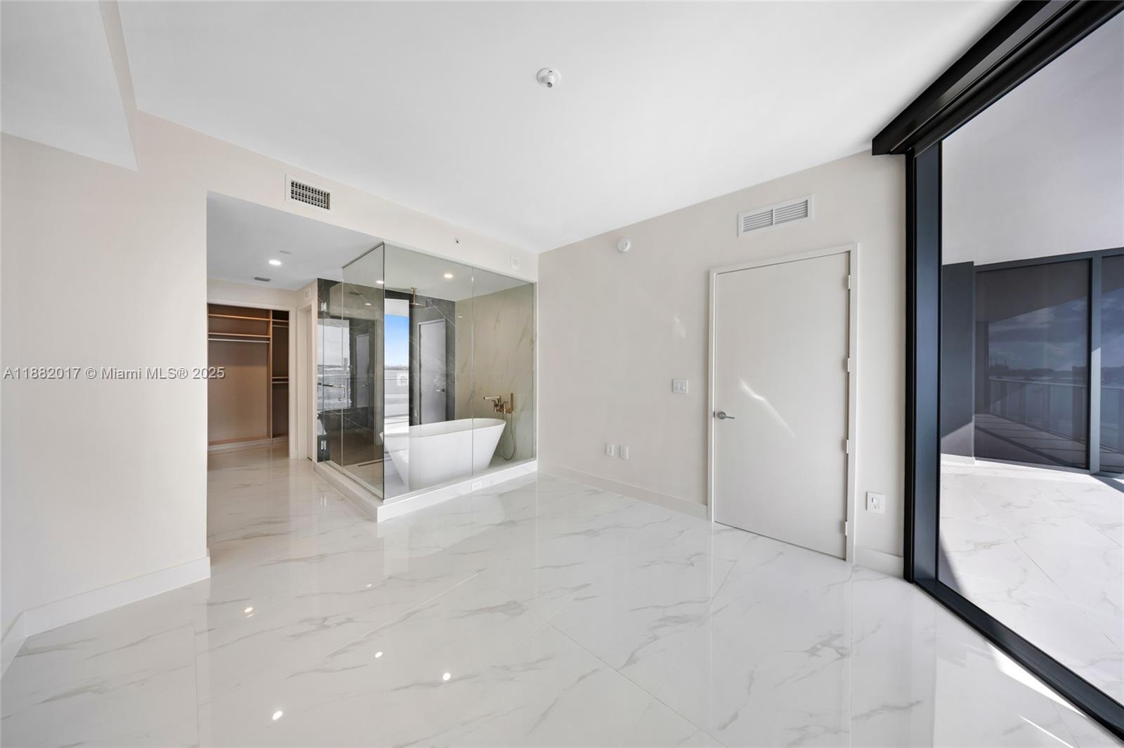 700 Northeast 24th Street, Unit 502 Miami, FL 33137 - Photo 14 of 25 a view of a hallway with wooden floor and a bathroom