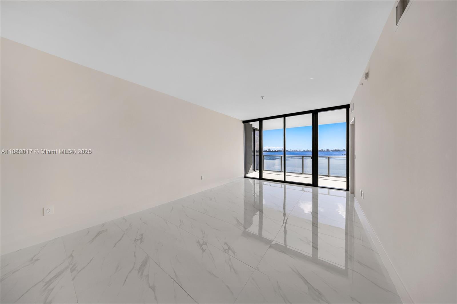 700 Northeast 24th Street, Unit 502 Miami, FL 33137 - Photo 17 of 25 wooden floor in an empty room with a window