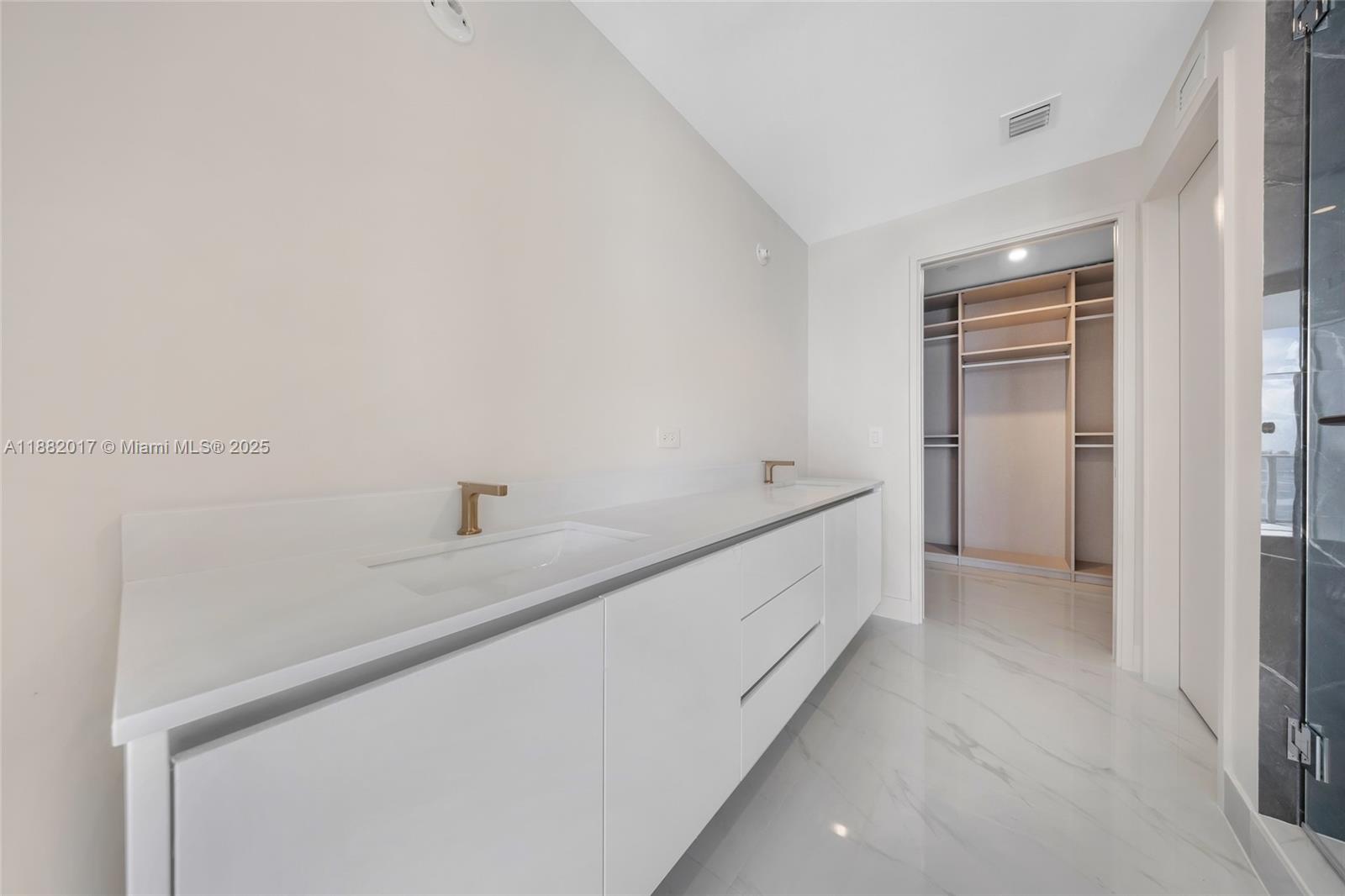 700 Northeast 24th Street, Unit 502 Miami, FL 33137 - Photo 22 of 25 a hallway with cabinet