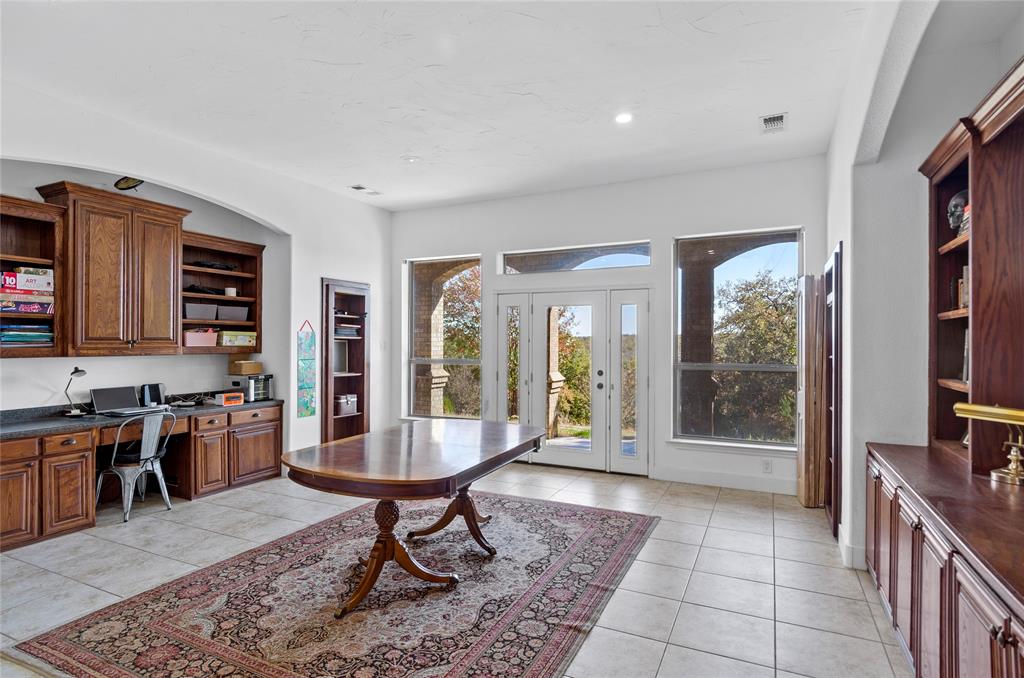 396 Ranchview Court Bowie, TX 76230 - Photo 18 of 38 a living room with furniture a rug and a floor to ceiling window