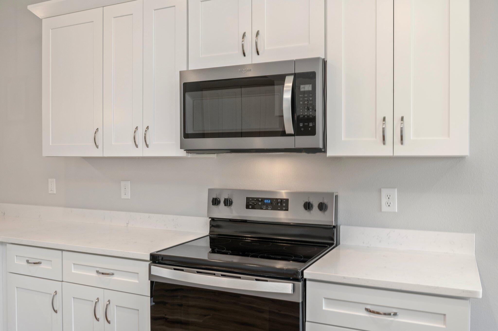 73 Lafayette Creek Freeport, FL 32439 - Photo 12 of 38 a kitchen with appliances a microwave and cabinets