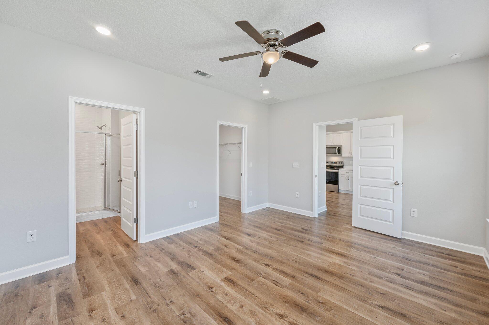 73 Lafayette Creek Freeport, FL 32439 - Photo 17 of 38 wooden floor in an empty room with a window