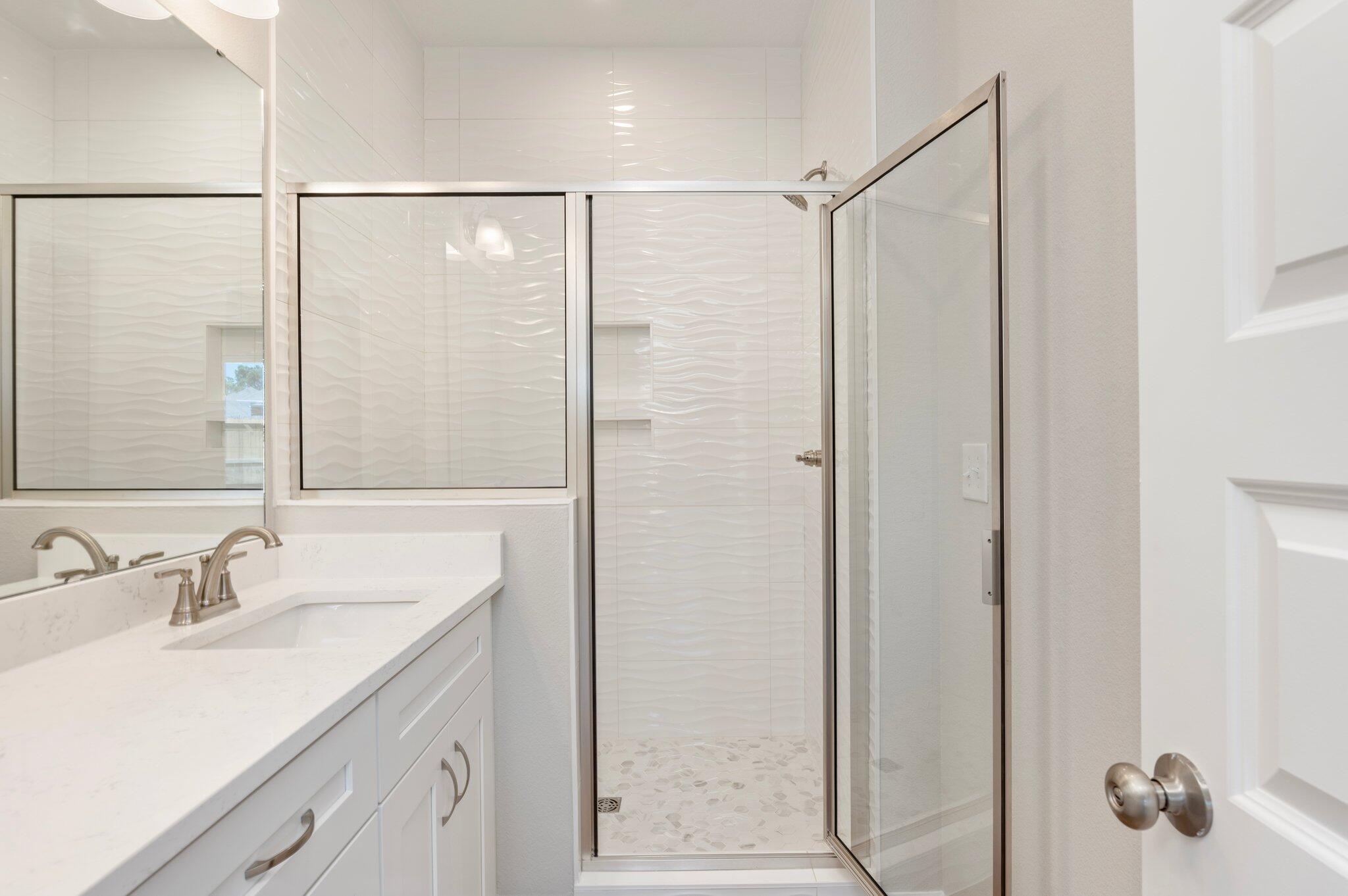 73 Lafayette Creek Freeport, FL 32439 - Photo 19 of 38 a bathroom with a shower sink vanity and mirror