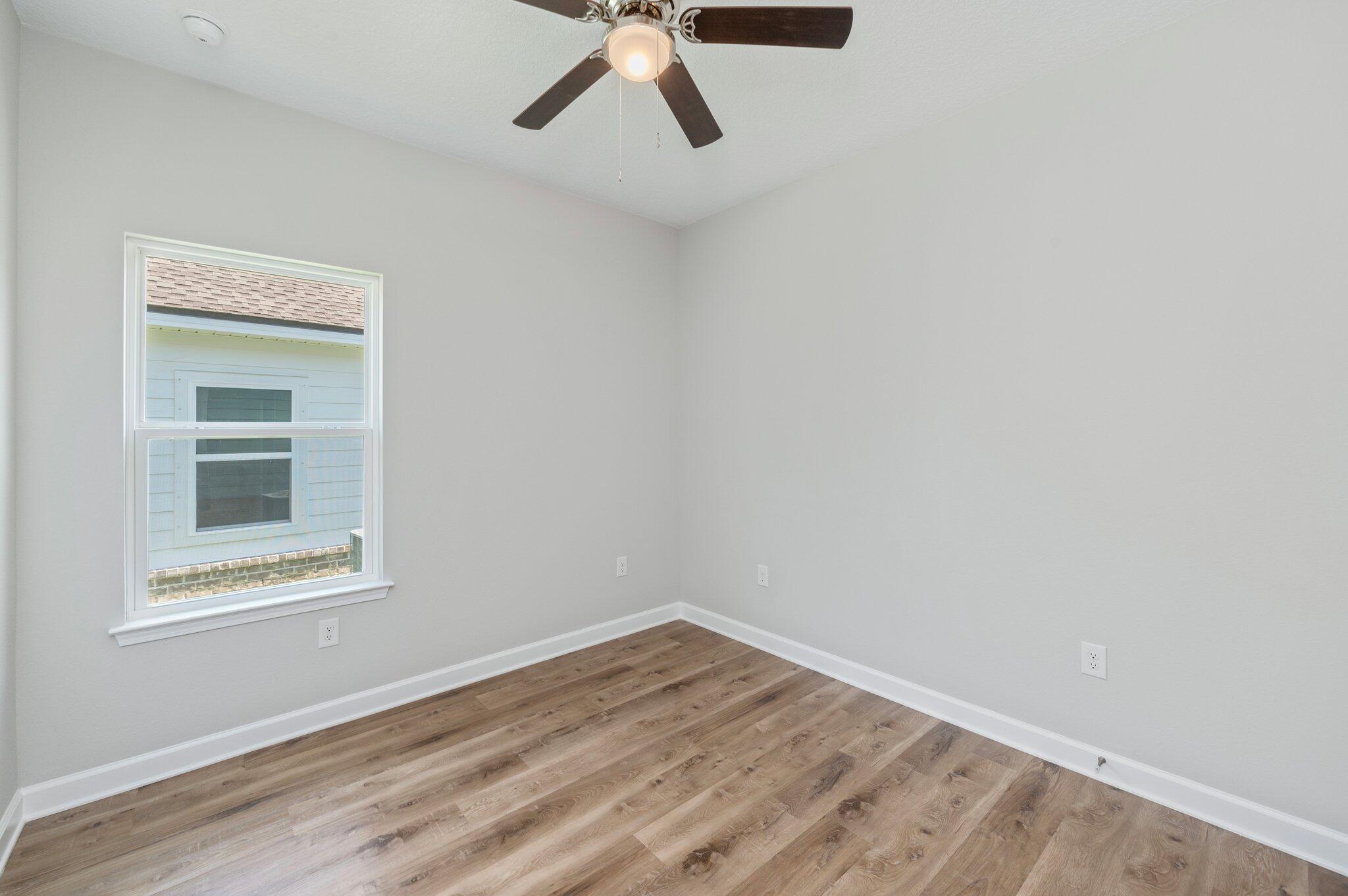 73 Lafayette Creek Freeport, FL 32439 - Photo 20 of 38 a view of an empty room with wooden floor and a window