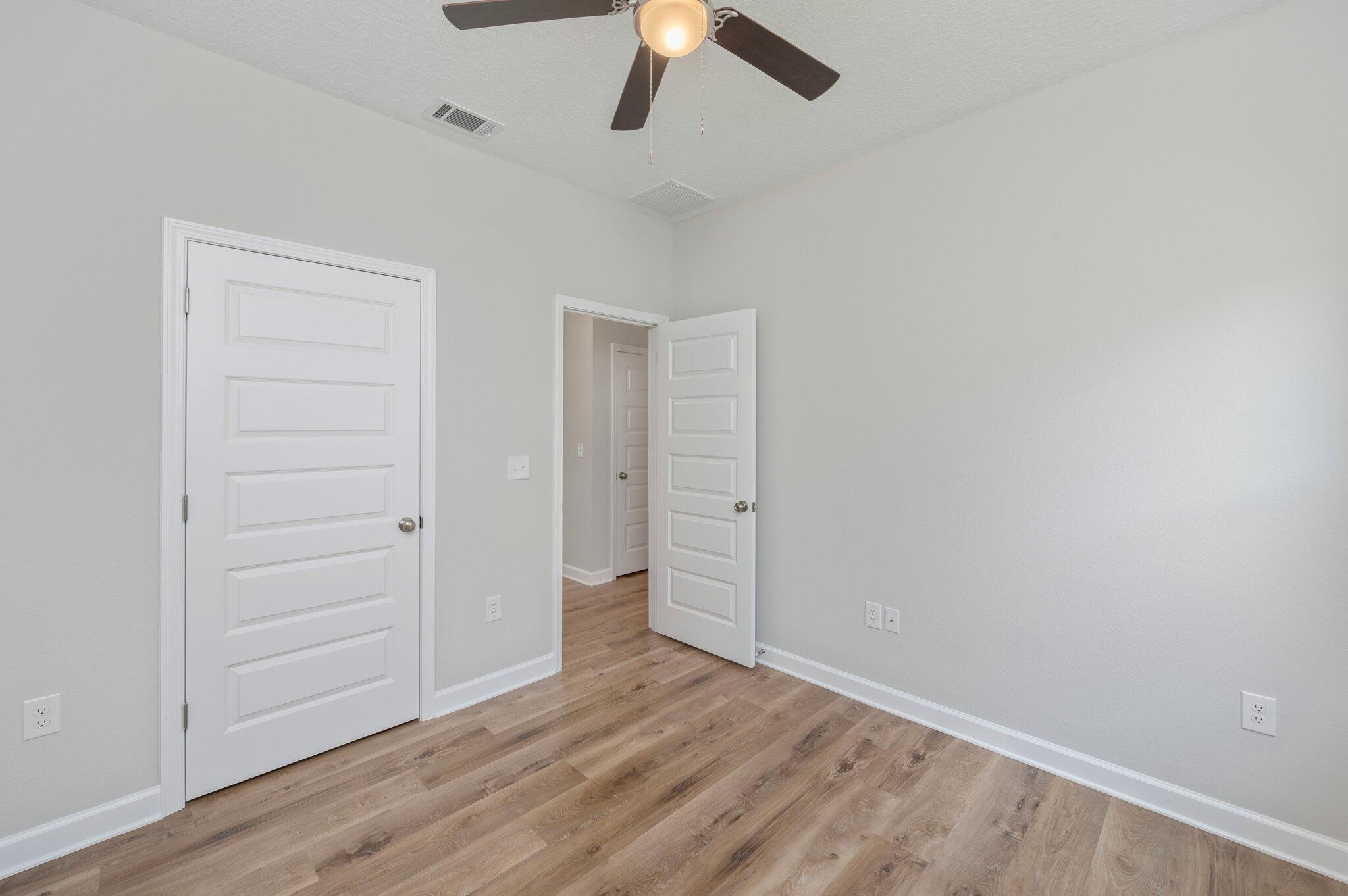 73 Lafayette Creek Freeport, FL 32439 - Photo 21 of 38 an empty room with a hardwood and ceiling fan