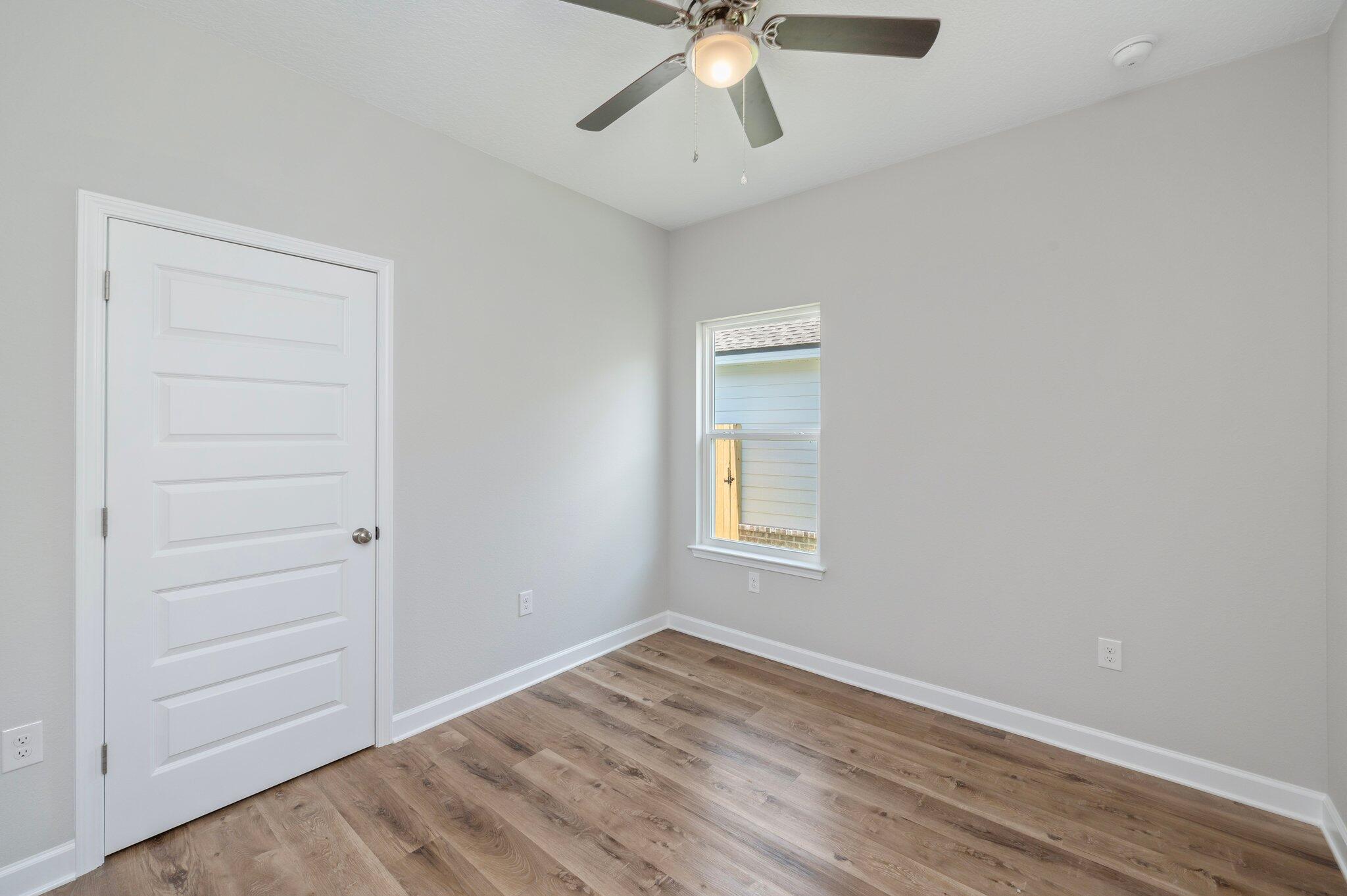 73 Lafayette Creek Freeport, FL 32439 - Photo 22 of 38 wooden floor in an empty room with a window