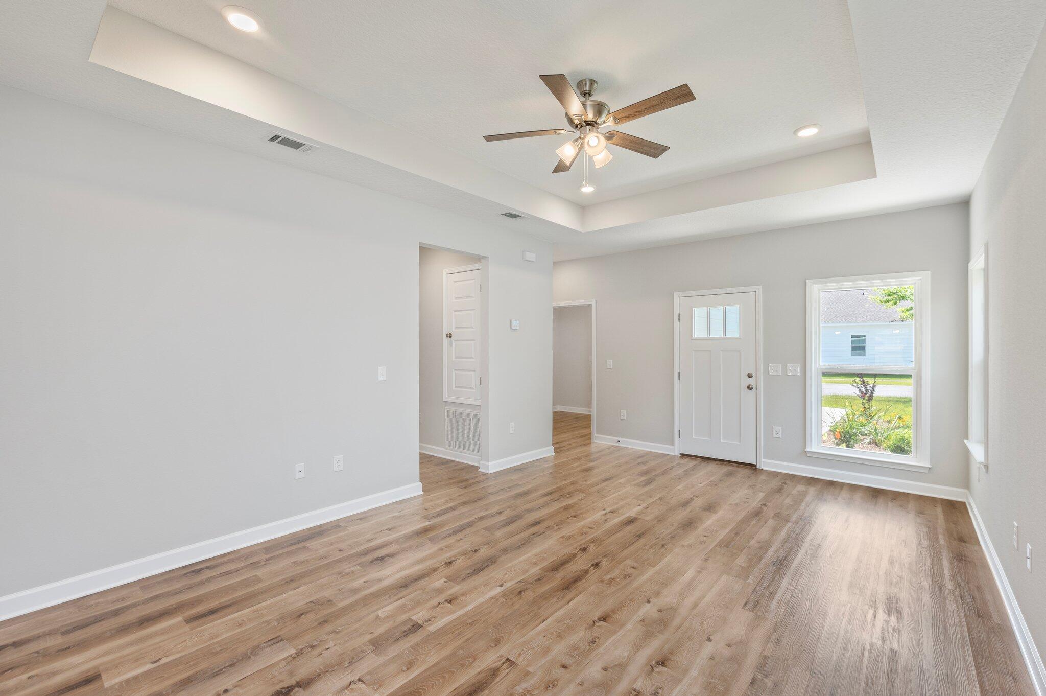 73 Lafayette Creek Freeport, FL 32439 - Photo 7 of 38 wooden floor in an empty room with a window